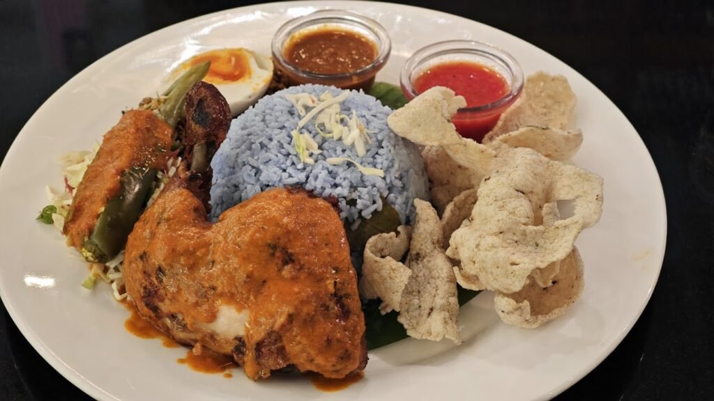 Nasi Kerabu Serai: Blue-tinted rice served with ayam percik, salted egg, ulam, solok lada, keropok ikan accompanied with budu sauce. Serai@Pavilion, Dining Loft, Pavilion KL