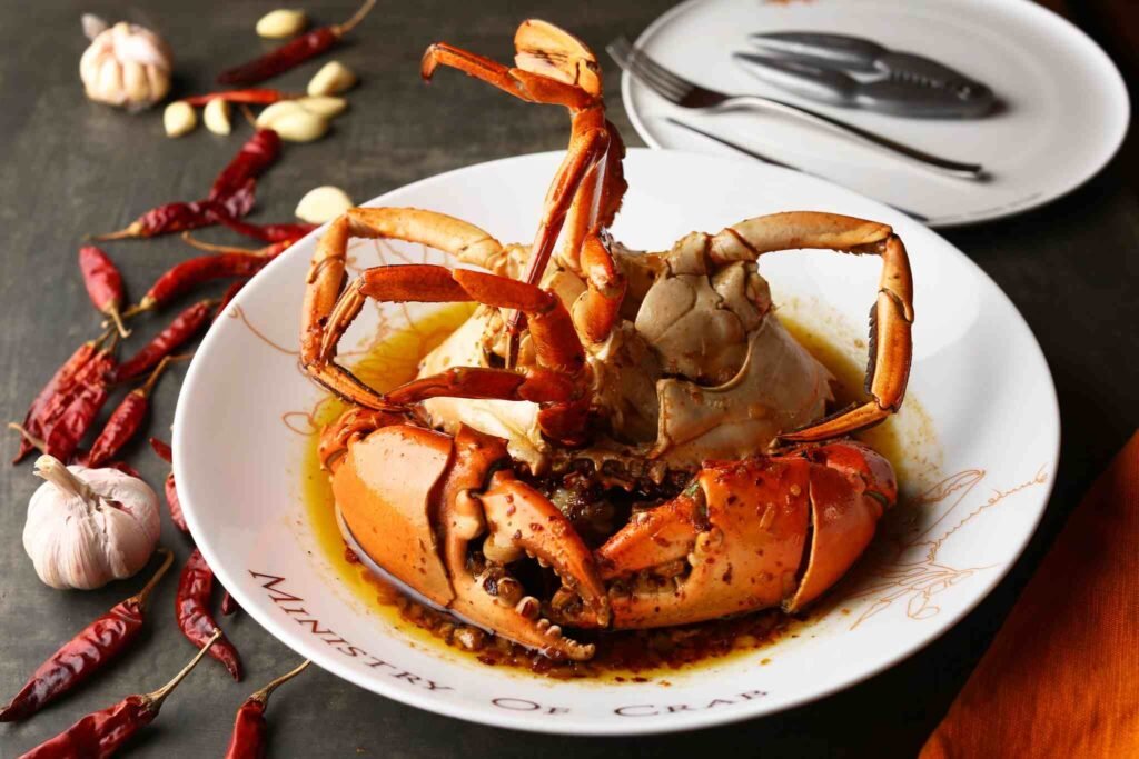 Garlic Chilli Crab Ministry Of Crab is a signature dish that blends Italian olive oil, garlic, Sri Lankan chilli flakes, and Japanese soy sauce, brought together by the rich, buttery depth of the thick crab shell.