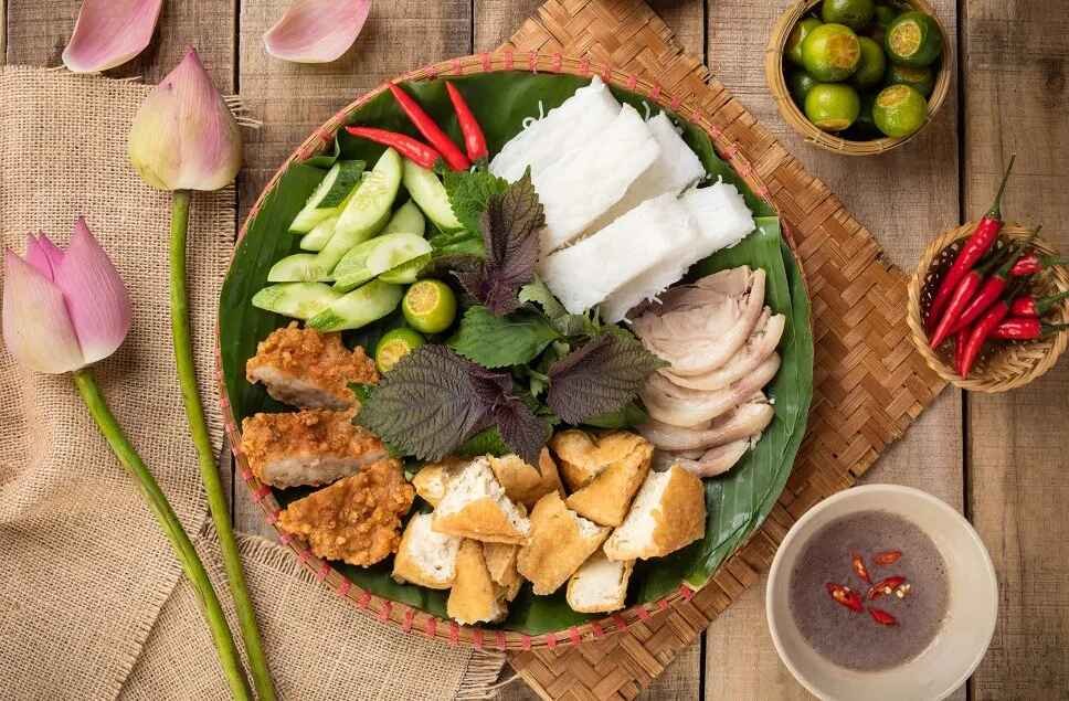 Bun Dau Mam Tom, a popular Vietnamese street food dish, especially in Hanoi, is a combination of rice vermicelli (bun), deep-fried tofu (dau), and fermented shrimp paste (mam tom). 