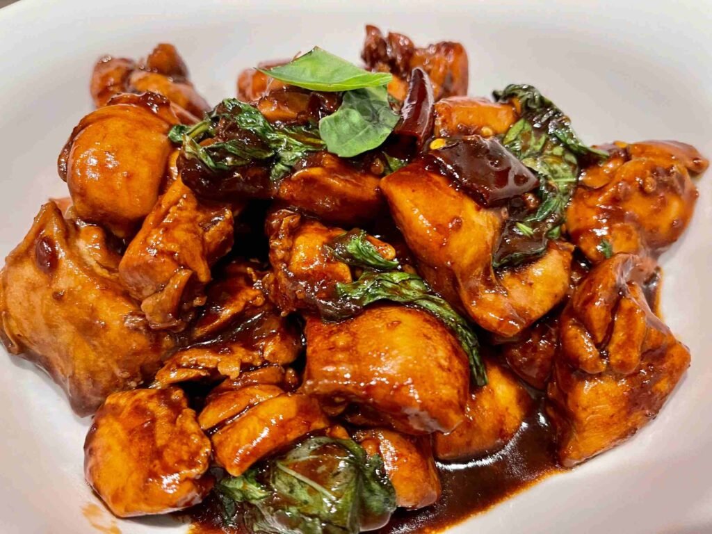 Taiwan Three Cups Chicken, also known as San Bei Ji, is a traditional Taiwanese dish known for its rich taste, made with equal parts soy sauce, sesame oil, and rice wine.
