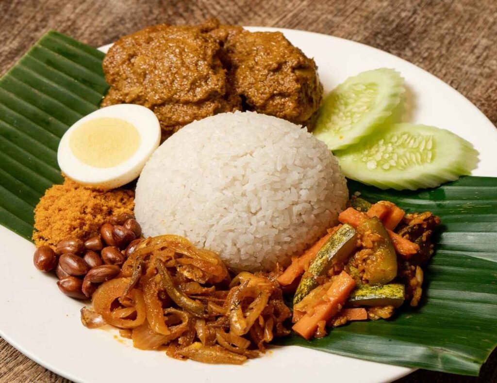 Nasi Lemak with Beef Rendang, Steamed rice cooked in coconut milk, served with beef rendang, sambal ikan bilis spicy anchovies, shrimp floss, hard boiled egg, acar spicy pickled vegetables & sliced cucumbers, a signature dish at Madam Kwan’s, Gourmet Emporium, Pavilion Kuala Lumpur