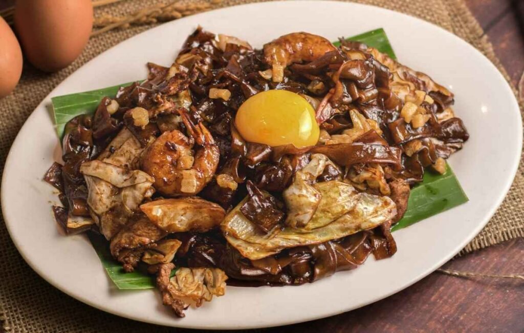 Moonlight Fried Kuey Teow, Penang style wok-fried flat rice noodles served with runny egg yolk and smoky aroma at Pavilion KL’s Food Place.