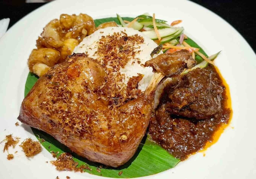 Serai Platter, a signature dish at Serai @ Pavilion KL, features serai rice served with portions of oxtail asam pedas, honey squid, fresh acar and ayam goreng berempah.