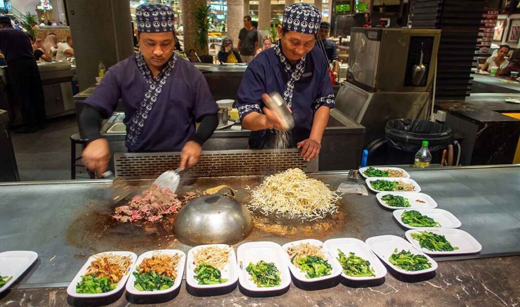 Chefs preparing the dishes on the grill in full view of customers at Teppanyaki Food Republic Pavilion KL