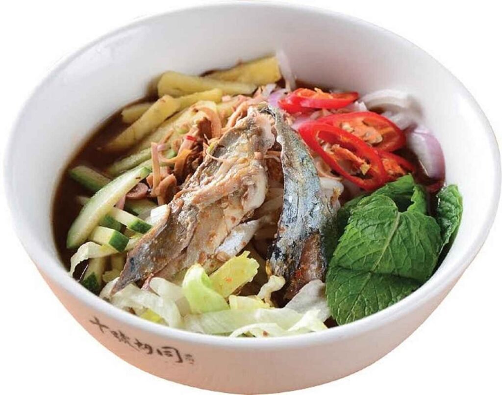 Penang Asam Laksa from Secret Penang Cafe at Lot 10 Hutong, a tangy and spicy noodle soup made with tamarind, mackerel, dried chillies, shrimp paste, shallots, cucumbers, torch ginger, laksa leaf, mint and lemongrass.