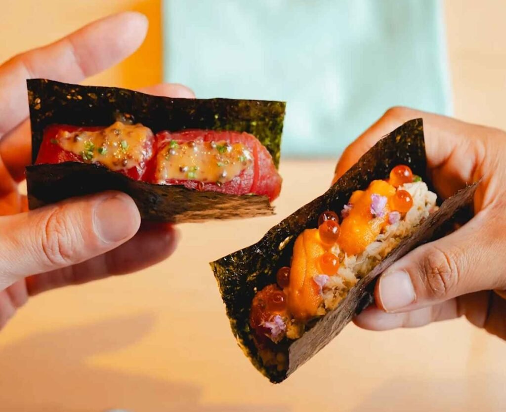 Exquisite Hand Roll Sushi at Nikaku by Azabu, The Table @ Isetan Lot 10, Bukit Bintang, Kuala Lumpur. Featured are the signature Nikaku Roll with uni (sea urchin), mud crab, ikura (salmon roe), and toro (fatty tuna), alongside Akamizuke (marinated lean tuna) & Mustard. A highlight of the unique omakase experience.