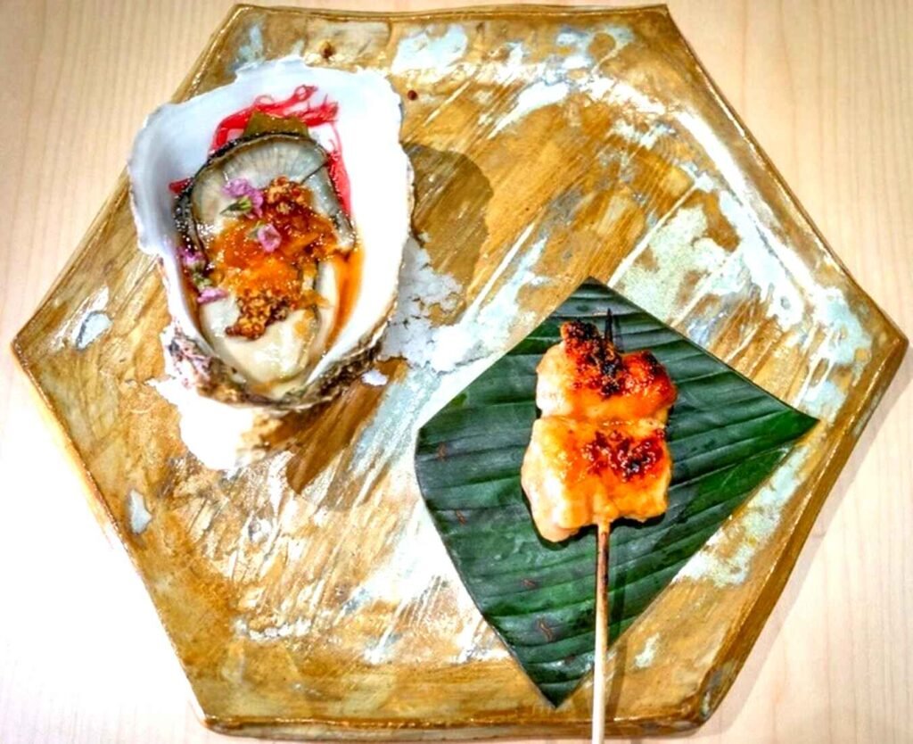 The Land and Ocean from the 12-course Malaya Mae Omakase at Nikaku by Azabu, Lot 10 features a huge oyster from Korea’s Jeju Island dressed with calamansi, pickled seaweed and mustard alongside a juicy teriyaki chicken satay glazed with the unique Cameron Highlands sweet corn sauce.