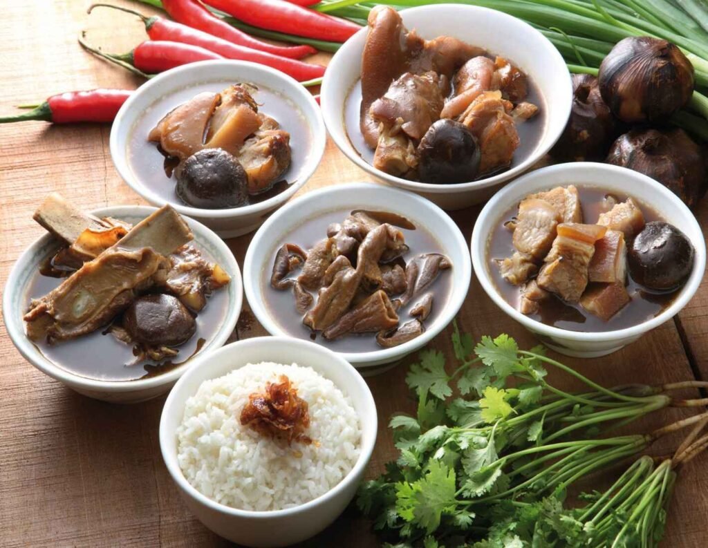 Ala carte bowls of Streaky Pork, Pork Ribs, Loin Ribs, Pork Knuckle, and Black Vinegar Pork Knuckle, along with a bowl of white rice, at Pin Qian Klang Bak Kut Teh in Lot 10 Hutong