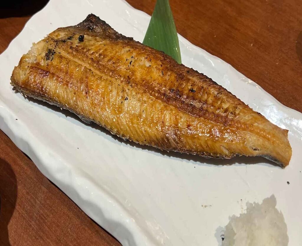 The Salt-Grilled Atka Mackerel, also known as Shima Hokke Shioyaki, is a flavourful, slightly smoky, and fatty fish that is typically gutted, butterflied, salted, and dried before being grilled, intensifying its flavour. A top rated seasonal dish at Mitsumori KL, The Table @ Isetan The Japan Store, Lot 10, Bukit Bintang, Kuala Lumpur.