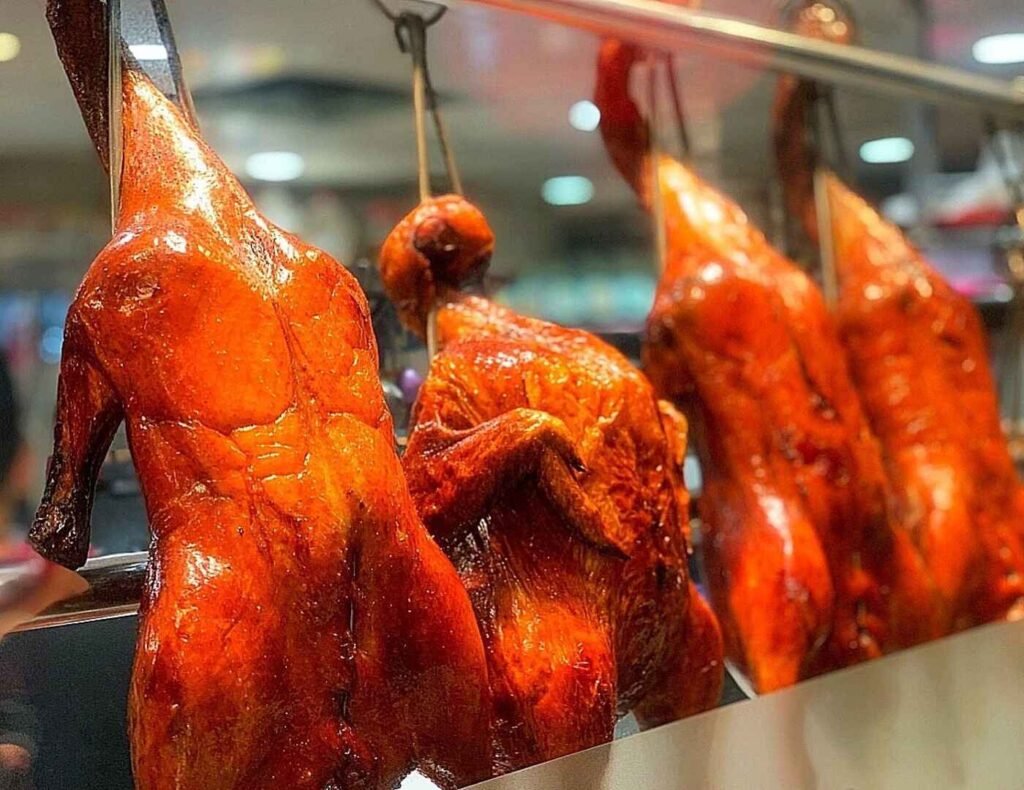 Glistening, perfectly cooked Signature Roasted Duck hanging on display at Roast Duckking, Lot 10 Hutong.