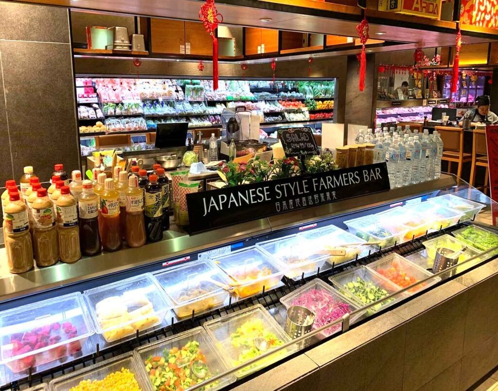 Japanese Style Farmers Bar and fresh salad bar featuring fresh vegetables, salad dressings, and a colorful array of prepared ingredients for customizable, high-quality Japanese salads at The Market, Lower Ground Floor, Isetan The Japan Store Lot 10, Bukit Bintang, Kuala Lumpur.