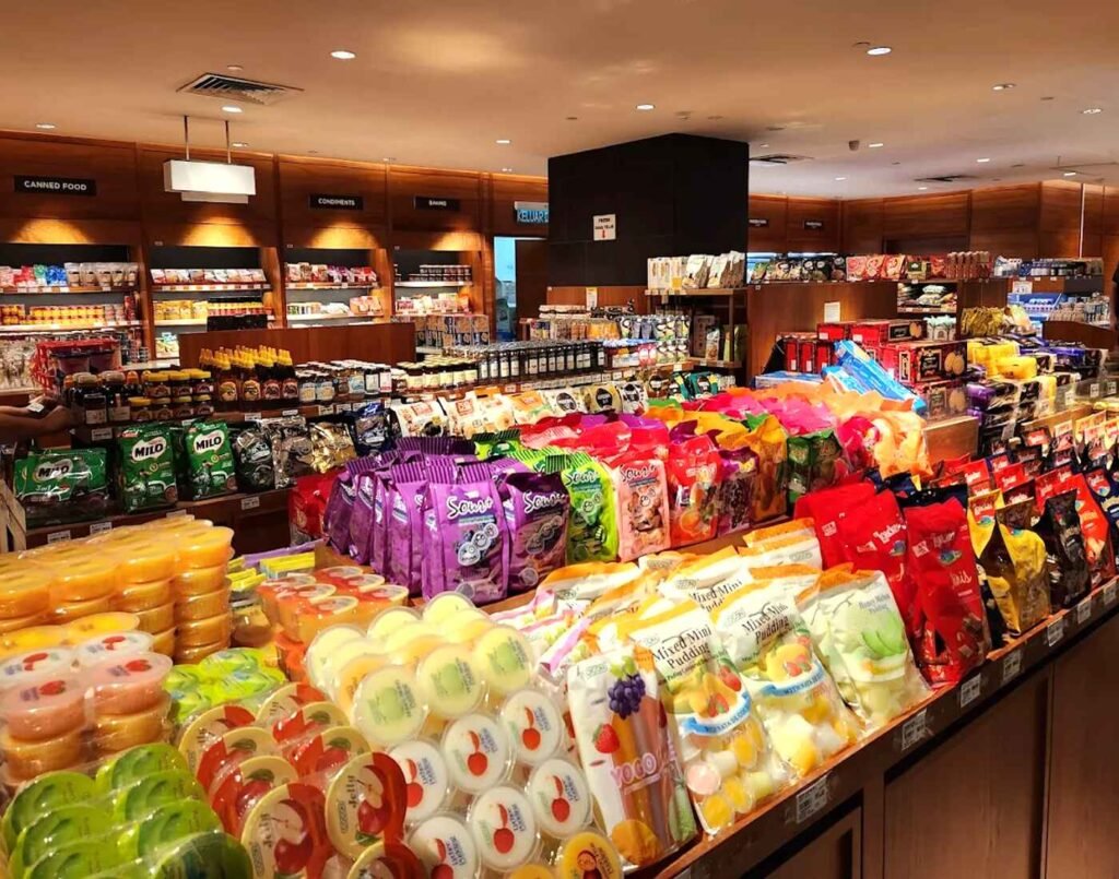 Fruit jelly cups (orange, apple, grape, lychee, mango, melon), assorted mixed-fruit jelly cups, Yogu fruit-flavoured jellies, assorted milk puddings, milk candies, chewy fruit candies (grape, peach, melon, lychee, mango), Sour candy packs (grape and mixed flavours), Nestlé Milo chocolate malt drink powder, bottled honey, canned food, condiments including soy sauce, mirin, teriyaki, ponzu, packaged beans and lentils, bottled sauces, dry snacks, cookies, biscuits, chips, and packaged bread and crackers, along with many more cereals, snacks and sweets available at The Market's Groceries section, located on the Lower Ground Floor of Isetan The Japan Store Lot 10, Bukit Bintang, Kuala Lumpur.