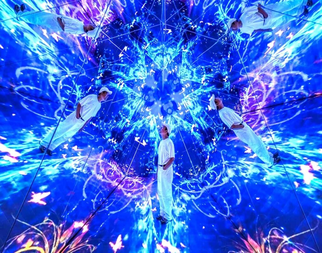 A man stands inside the kaleidoscope tunnel in Quantum Decoding, where mirrored walls and vibrant digital projections create a multi-dimensional, infinite reflection effect of light and color. A favourite Instaworthy zone at Space & Time Cube, The Amusement, Third Floor, Isetan The Japan Store Lot 10, Bukit Bintang, Kuala Lumpur.