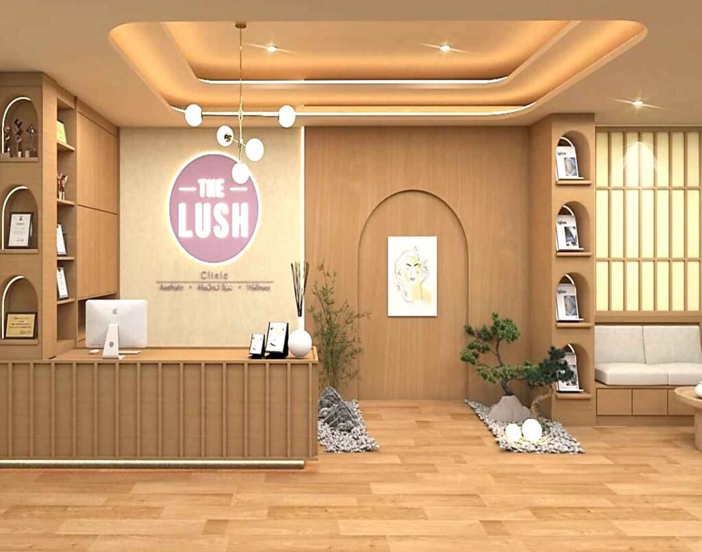 The reception area of The Lush Clinic, with a light wood-paneled counter, a warm, ambient lighting scheme, and clean, minimalist decor. The space features a prominent clinic logo, an indoor bonsai tree, and comfortable seating, reflecting a calming, high-end, and professional aesthetic for medical aesthetics and wellness services. Located at The Wellness, Second Floor, Isetan The Japan Store Lot 10, Bukit Bintang, Kuala Lumpur.