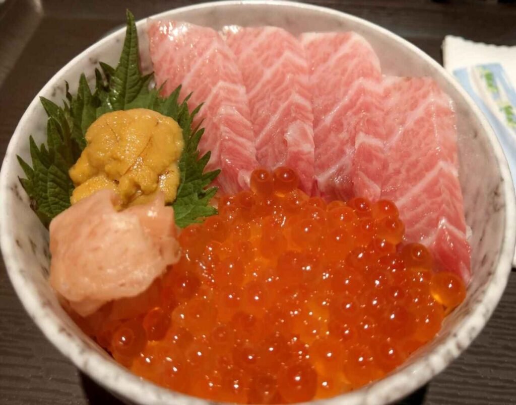 The Toro Kaisen Don features four slices of tuna belly, uni (sea urchin), and ikura (salmon roe), all served over a bed of seasoned sushi rice. A highly rated dish at Hirashima Sushi, a sushi bar specialising in fresh, ready-to-eat sushi and sashimi located at The Market, Lower Ground Floor, Isetan The Japan Store Lot 10, Bukit Bintang, Kuala Lumpur.