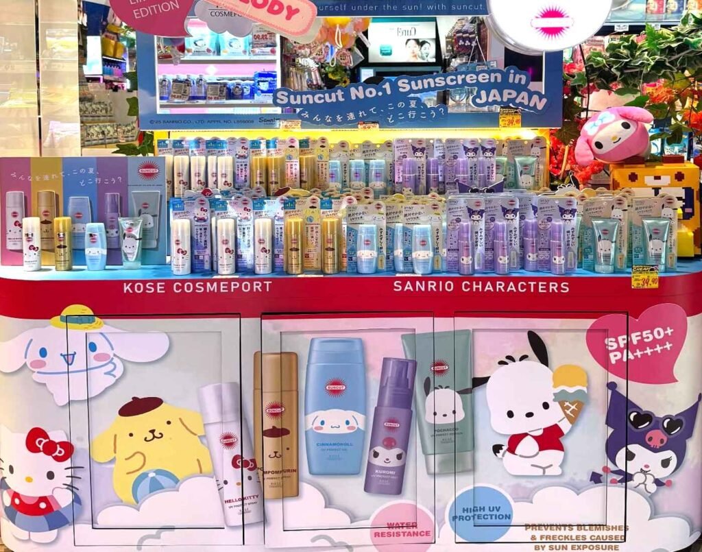Sanrio character sunscreen display at CosmeDONKI featuring KOSÉ Cosmeport Suncut UV products with Hello Kitty, Cinnamoroll, Kuromi, Pochacco and Pompompurin packaging at Don Don Donki Lot 10 in Bukit Bintang, Kuala Lumpur.