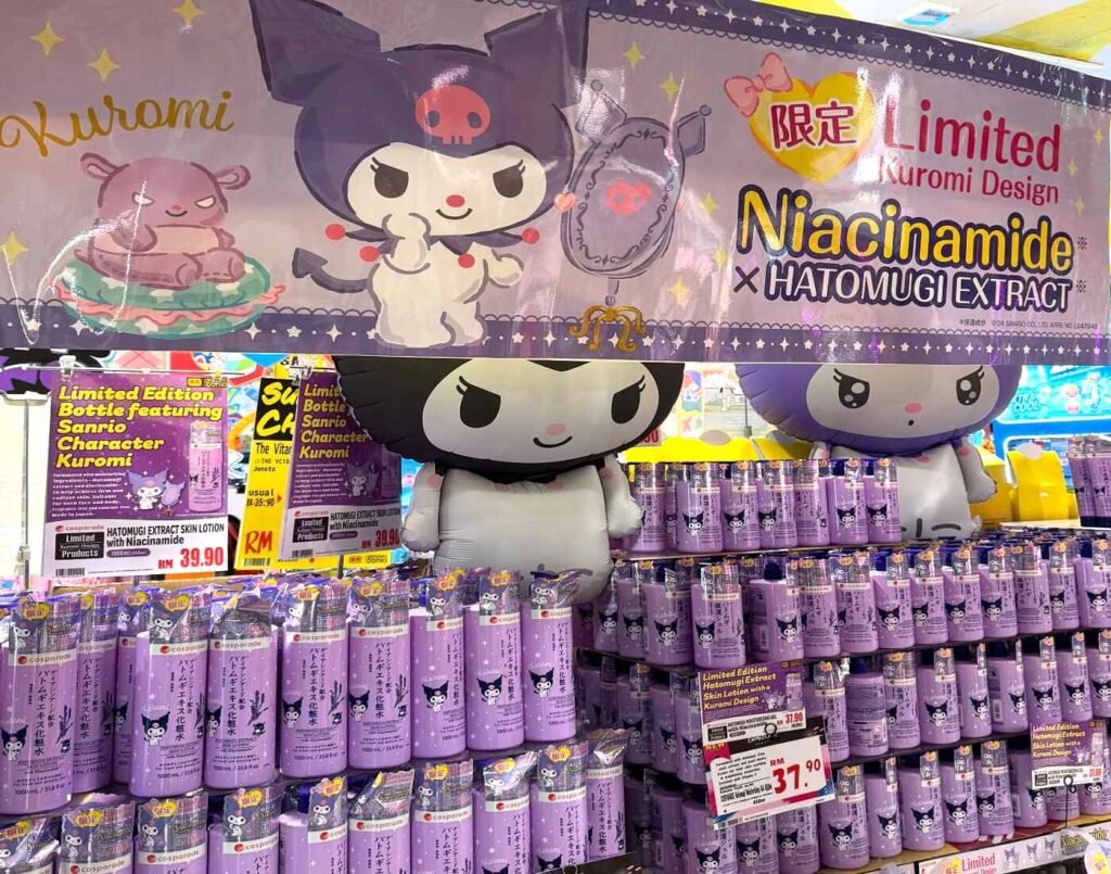 Cosparade limited edition Kuromi skin lotion bottles featuring Hatomugi extract and niacinamide stacked in a large promotional setup at CosmeDONKI inside Don Don Donki Lot 10, Bukit Bintang, Kuala Lumpur.