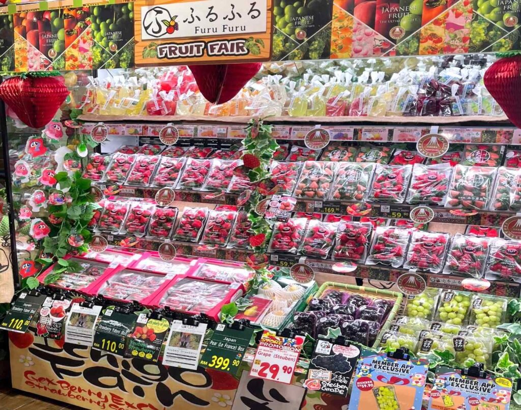 Furu Furu Fruit Fair display featuring premium Japanese fruits such as Amaou, Yubeni, Awayuki & Kaorino strawberries, Shine Muscat, Kyoho & Steuben grapes, along with more than 10 flavours Furu Furu Fruit Jelly including Japanese grape, shonan gold, mikan, yuzu, & peach, all beautifully packaged and air-flown from Japan. Displayed in the fresh produce section at Jonetz By Don Don Donki Lot 10, a Japanese supermarket in Bukit Bintang, Kuala Lumpur.