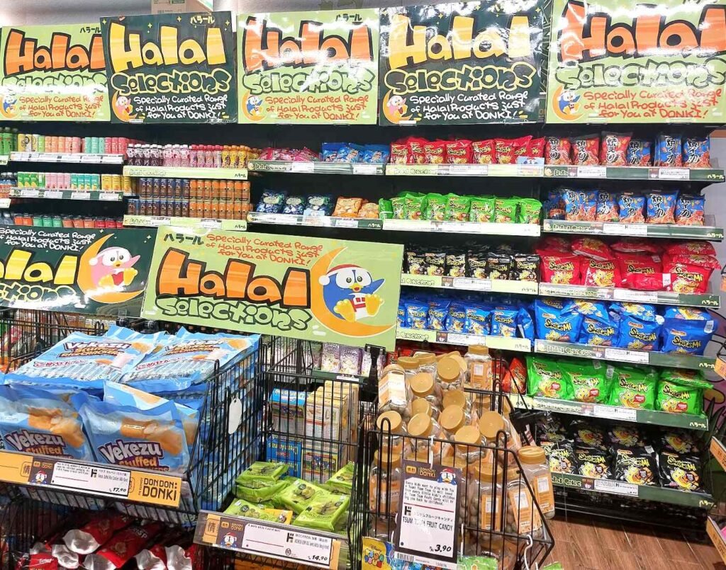 The dedicated Halal Selections section for beverages such as tea, juices and milk drinks along with sweet and savoury snacks such as potato chips, mochi, fruit candies, gummies, biscuits, and rice crackers, offering both bulk and single-serve Halal-certified Japanese treats at promotional prices at Jonetz By Don Don Donki Lot 10, a Japanese supermarket in Bukit Bintang, Kuala Lumpur.