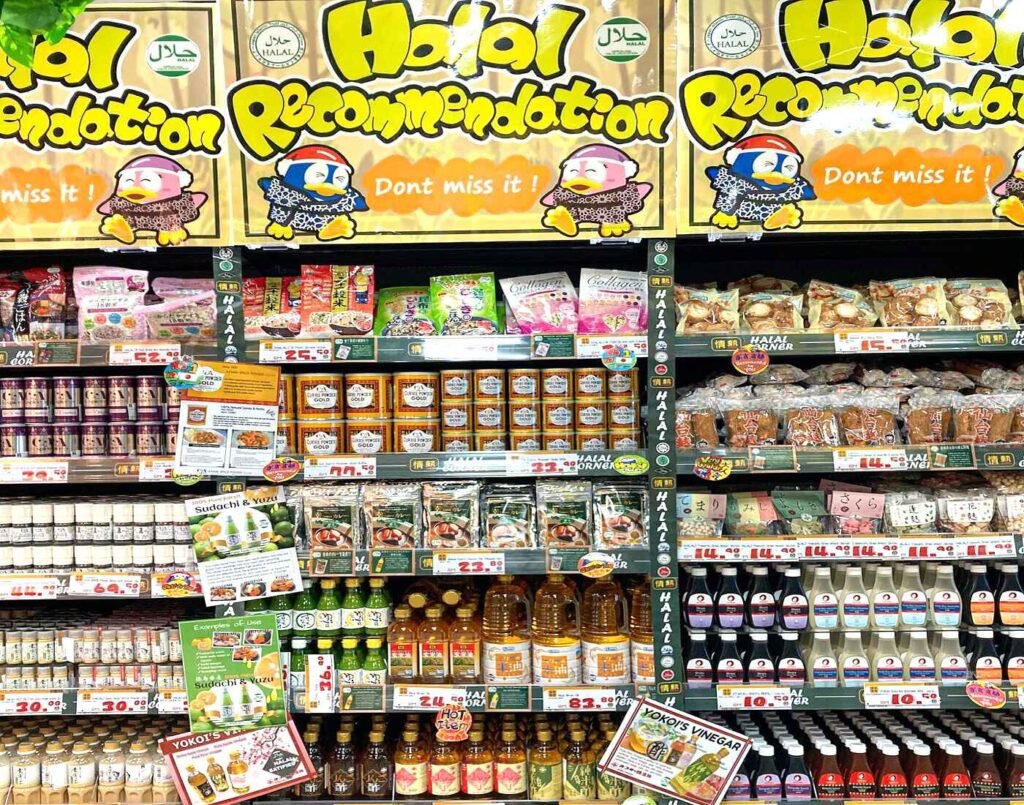 Halal Recommendation section, displaying Halal-certified Japanese cooking ingredients, sauces (like Sudachi & Yuzu), vinegars, oils and supplement powders with promotional price labels at Jonetz By Don Don Donki Lot 10, a Japanese supermarket in Bukit Bintang, Kuala Lumpur.