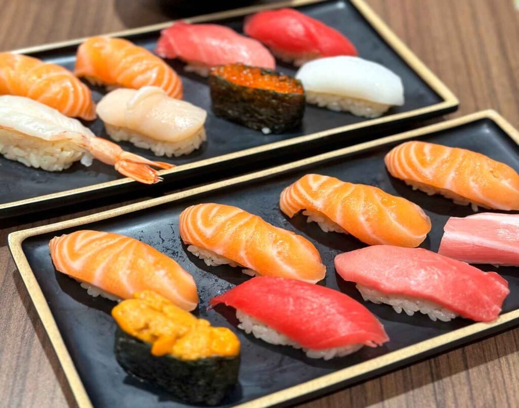 Himawari Sushi Set and Sakura Sushi Set at Uohama Live Kitchen in Don Don Donki Lot 10, featuring fresh tuna, salmon, scallops, ikura, and creamy uni (sea urchin) on red vinegar rice.