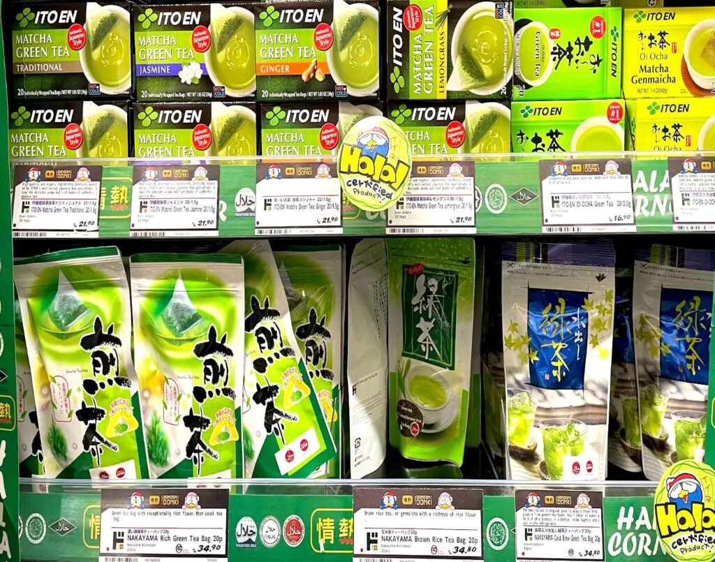 Shelf display of Halal-certified Japanese green tea powders and bags, featuring ITO EN Matcha Green Tea (Traditional, Jasmine, Ginger, Lemongrass, Oi Ocha Green Tea & Oi Ocha Matcha Genmaicha) and NAKAYAMA (Rich Green Tea, Brown Rice & Cold Brew Green Tea) at Jonetz By Don Don Donki Lot 10, a Japanese supermarket in Bukit Bintang, Kuala Lumpur.
