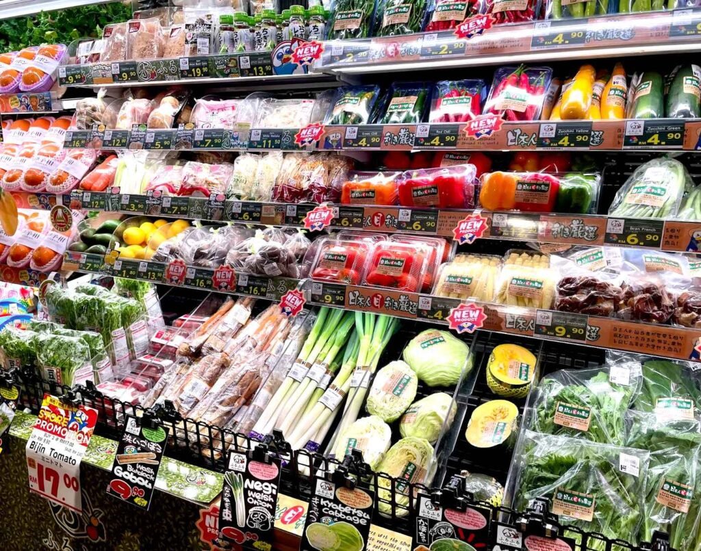 Fresh Japanese fruits and vegetables including daikon radish, negi leek, enoki mushrooms, bijin tomatoes, baby corn, capsicum, avocado and gobou (burdock root) displayed in the produce section at Don Don Donki Lot 10 in Kuala Lumpur.