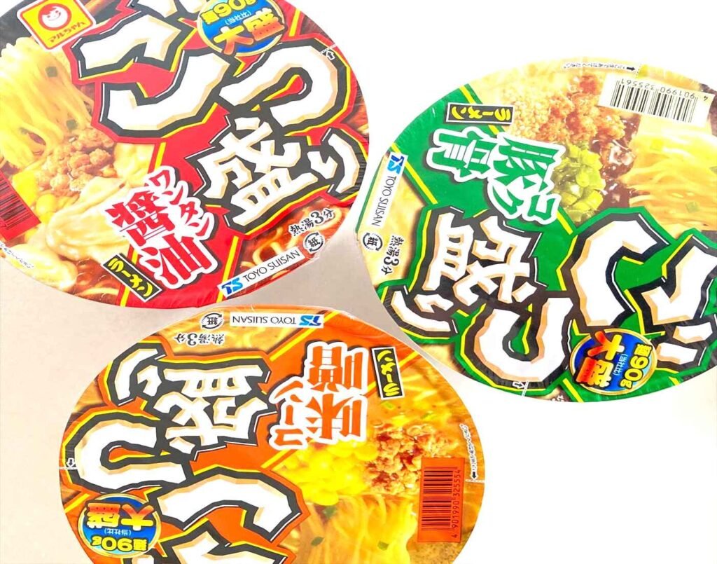 Large-serving MARUCHAN Gotsumori instant cup ramen in Tonkotsu, Corn Miso, and Wantan Shoyu flavours, known for its extra-large portions compared to standard Japanese cup noodles, displayed at Jonetz By Don Don Donki Lot 10.