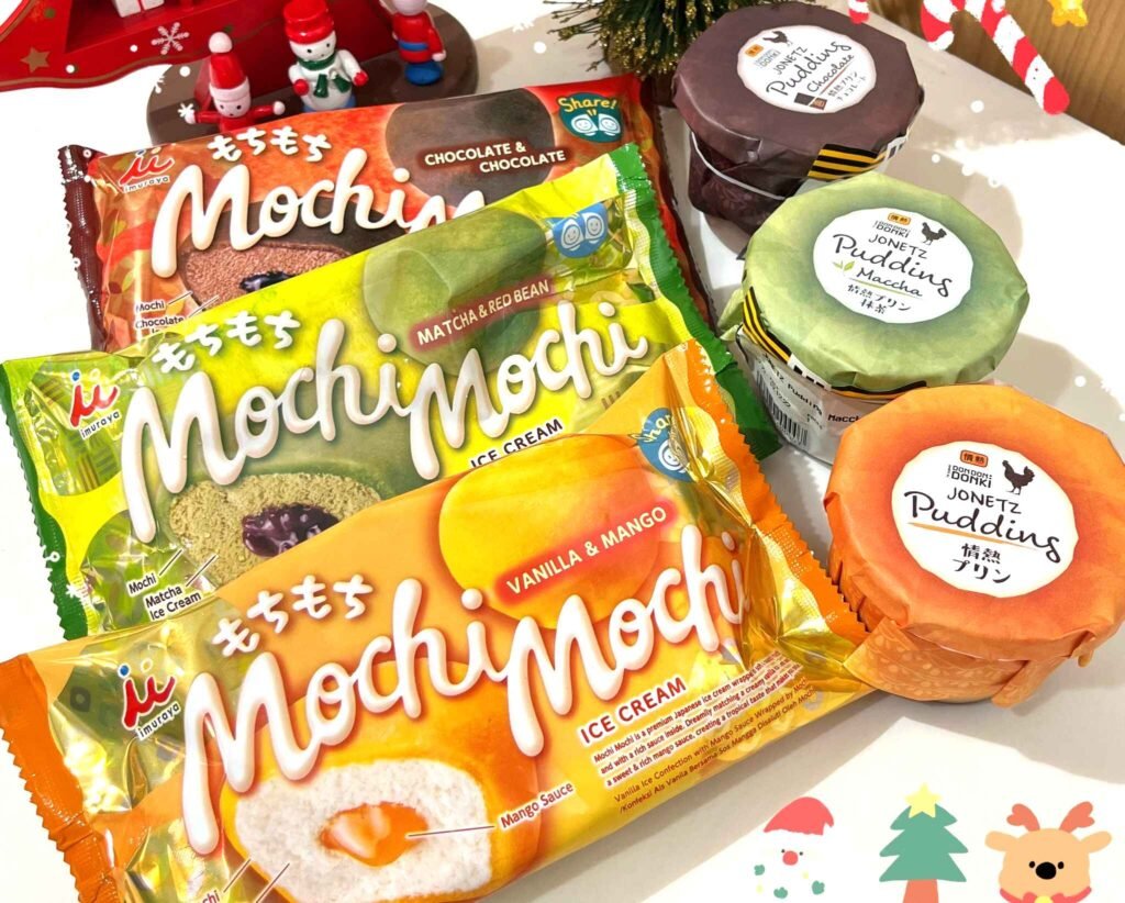 A festive display of Mochi Mochi Ice Cream (vanilla & mango, matcha & red bean, chocolate flavours) and Jonetz custard puddings (matcha, chocolate, plain custard flavours), arranged with Christmas decorations at Jonetz By Don Don Donki Lot 10 in Bukit Bintang, Kuala Lumpur.