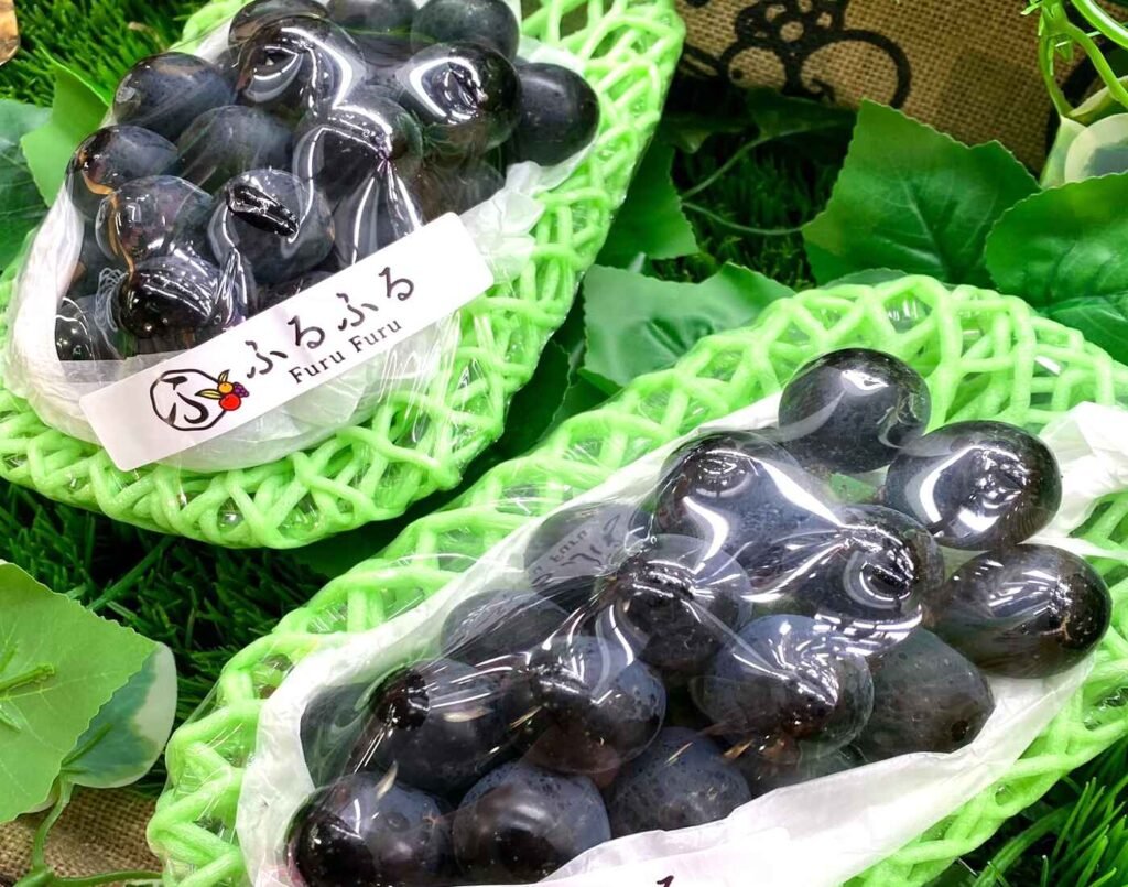 Premium Nagano Purple Grapes from Japan, known for their large, seedless berries, firm translucent flesh, and glossy dark-purple skin, displayed in the Furu Furu premium fruits section at Jonetz By Don Don Donki Lot 10, a Japanese supermarket in Bukit Bintang, Kuala Lumpur.