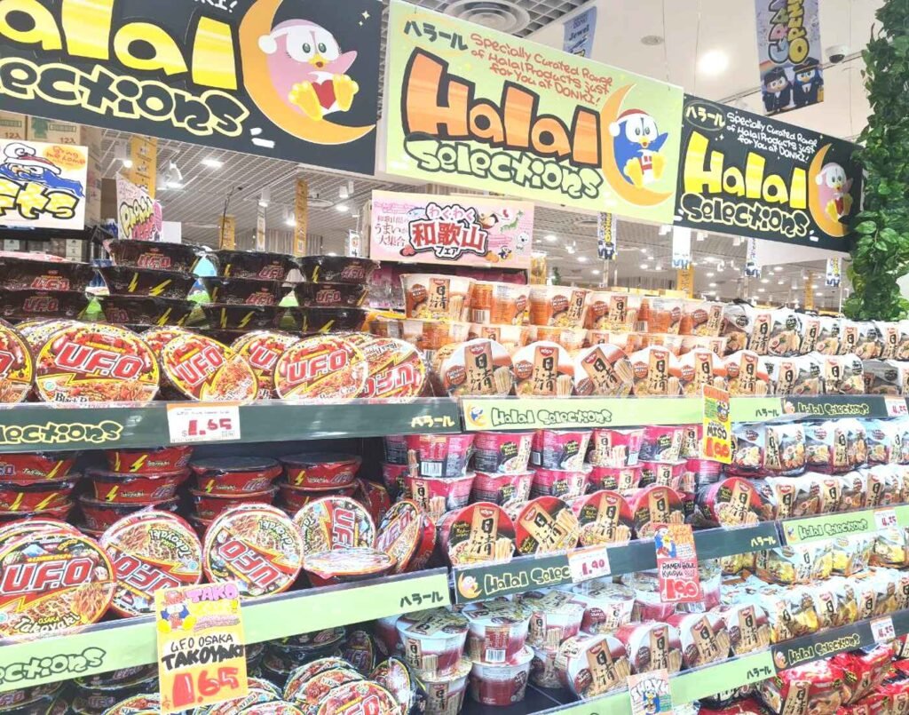 Dedicated Halal section featuring a wide array of Halal-certified instant cup ramen and other Japanese noodles, clearly marked by large orange ‘Halal Selections’ banners on the First Floor of Jonetz By Don Don Donki Lot 10, a Japanese supermarket in Lot 10, a famous shopping mall in Bukit Bintang, Kuala Lumpur.