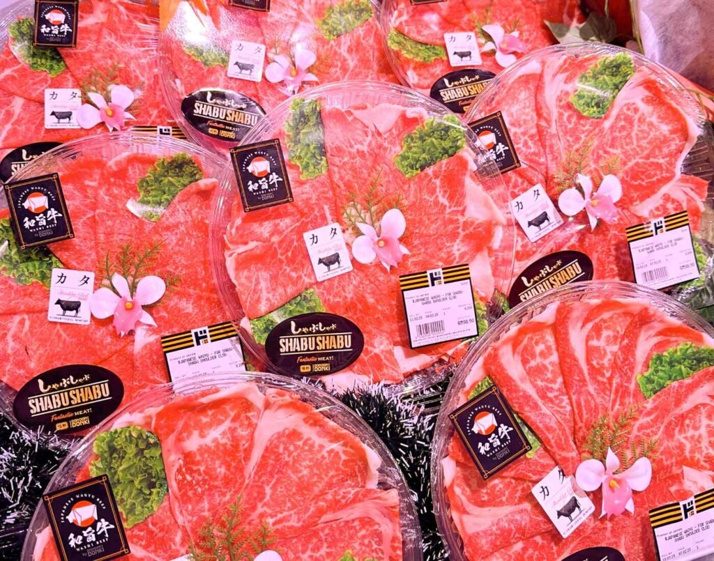 Thinly sliced shabu-shabu wagyu platter packs in a refrigerated display in the fresh meat section at Jonetz By Don Don Donki Lot 10, a Japanese supermarket in Bukit Bintang, Kuala Lumpur.