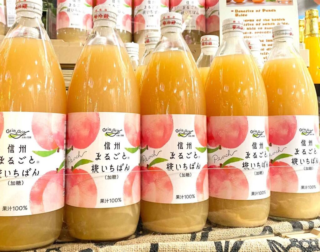 Bottles of Shinshu Marugoto Peach Ichiban juice by Grinagrin, a 100% peach juice made from peaches grown in the Nagano prefecture of Japan, on display at the drinks section of Jonetz By Don Don Donki Lot 10, a Japanese supermarket in Bukit Bintang, Kuala Lumpur.