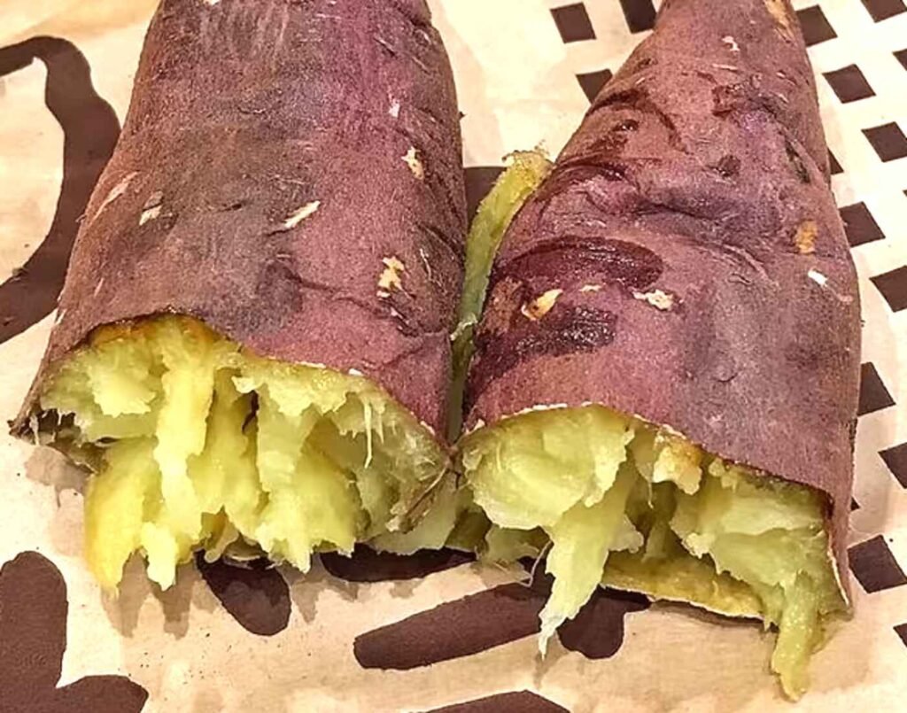 Freshly roasted Japanese sweet potato (Yakiimo) with golden caramelized skin, made from premium Beni Haruka and Anno Imo varieties, served hot at the Sweet Potato Factory, a famous street food kiosk at Jonetz By Don Don Donki Lot 10, a Japanese supermarket in Bukit Bintang, Kuala Lumpur.
