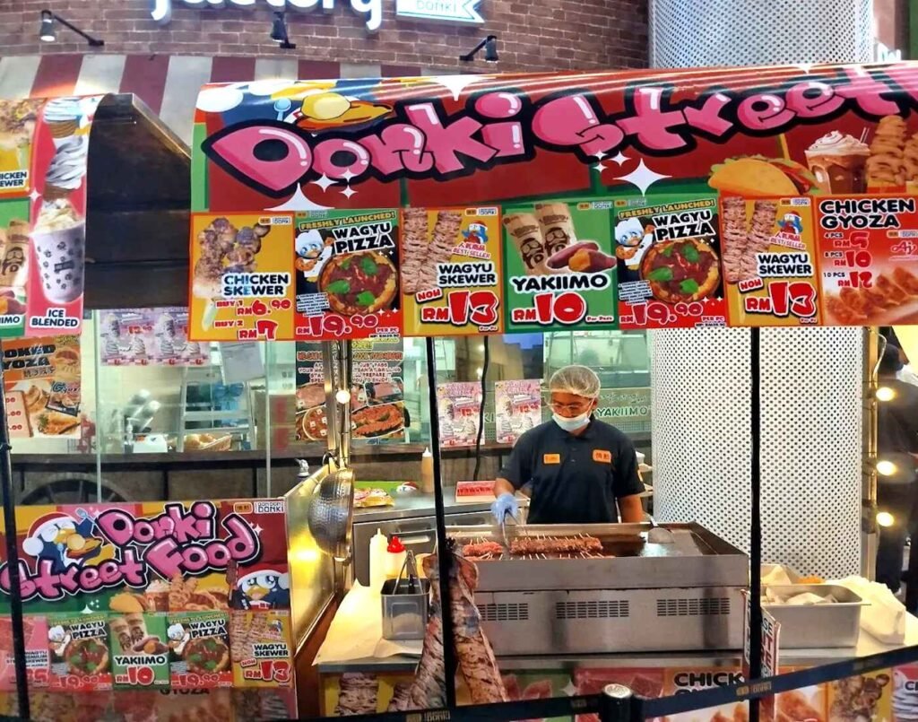 Sweet Potato Factory stall serving roasted Japanese sweet potatoes along with other popular Japanese street food including pizza, wagyu and chicken skewers at Don Don Donki Lot 10, Bukit Bintang, Kuala Lumpur.