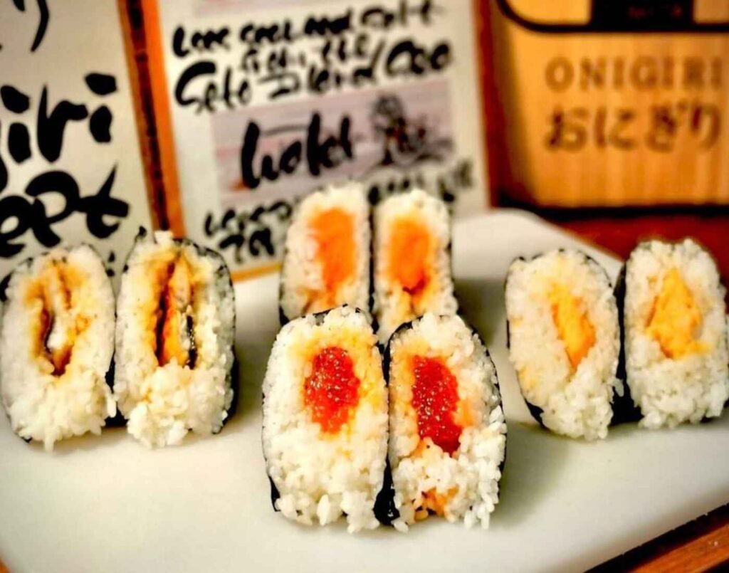 Assorted nori-wrapped onigiri at Tomita Seimai showing packaged rice balls (Onigiri) with varied toppings and fillings such as Unagi, Aomori Salt Salmon, Aomori Sujiko and Mentaiko. Available at Jonetz By Don Don Donki Lot 10, a Japanese supermarket in Bukit Bintang, Kuala Lumpur.