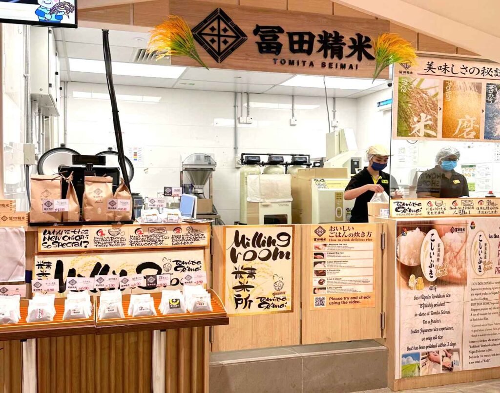 Tomita Seimai outlet counter and kitchen with chefs preparing rice and onigiri for dine-in customers on the 2nd floor of Jonetz By Don Don Donki Lot 10, a Japanese supermarket in Bukit Bintang, Kuala Lumpur.