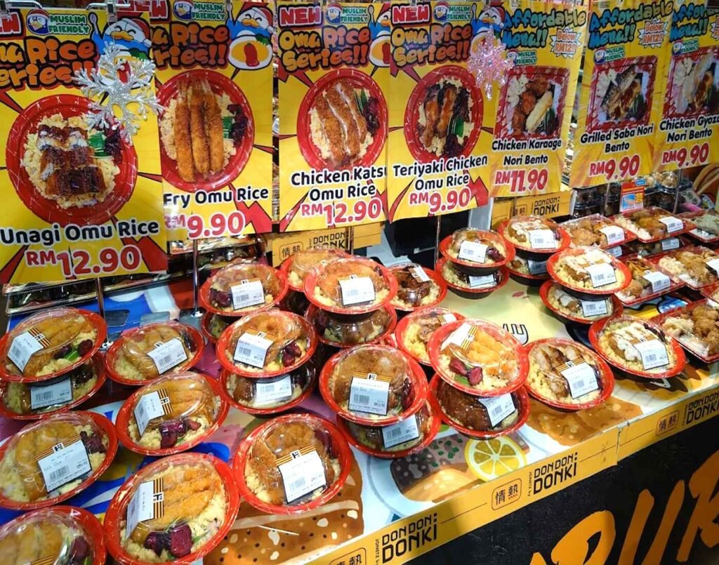 Assorted ready-to-eat Japanese bento boxes featuring Unagi Omurice, Ebi Fry Omurice, Chicken Katsu Omurice, Teriyaki Chicken Omurice, Karaage Chicken Nori Bento, Grilled Saba Nori Bento, and Grilled Gyoza Nori Bento on display at the ready-to-eat section at Jonetz By Don Don Donki Lot 10, a Japanese supermarket in Bukit Bintang, Kuala Lumpur.