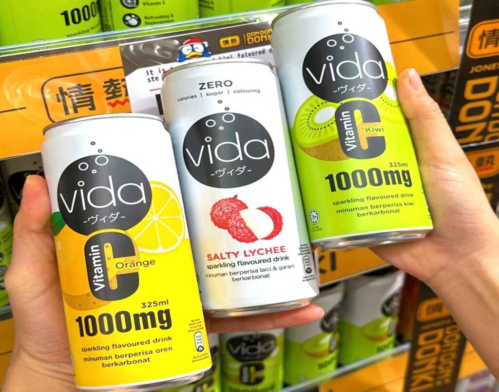 White and silver cans of Vida Sparkling Flavoured Drink featuring Vitamin C Orange, Salty Lychee, and Vitamin C Kiwi flavours, available at Jonetz By Don Don Donki Lot 10, a Japanese supermarket in Bukit Bintang, Kuala Lumpur.