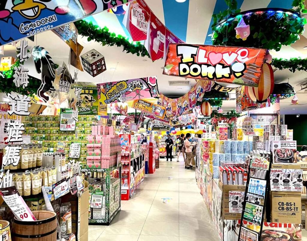 The CosmeDONKI beauty and lifestyle section at JONETZ by Don Don Donki Lot 10, featuring stacks of Japanese skincare, personal care products, and colourful "I Love Donki" signage.